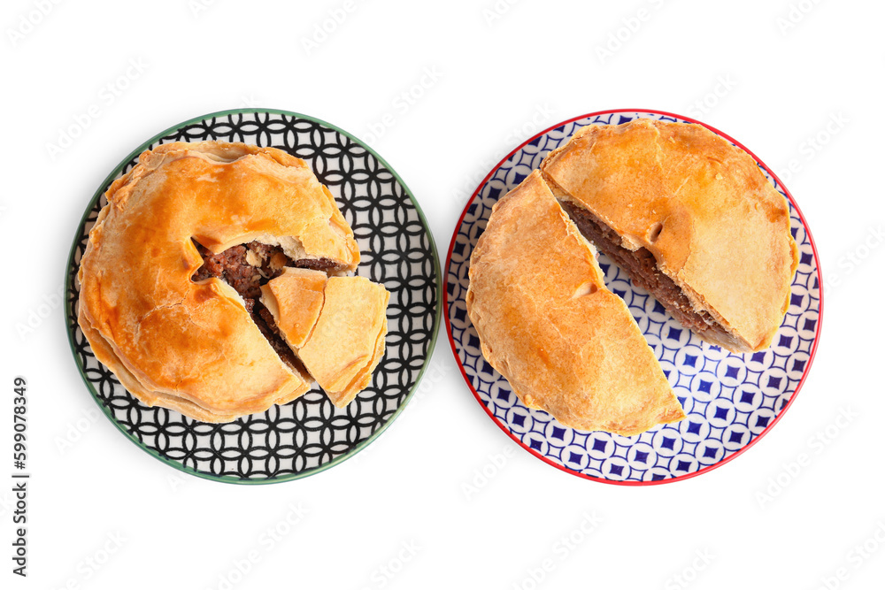 Plates with tasty meat pot pie on white background