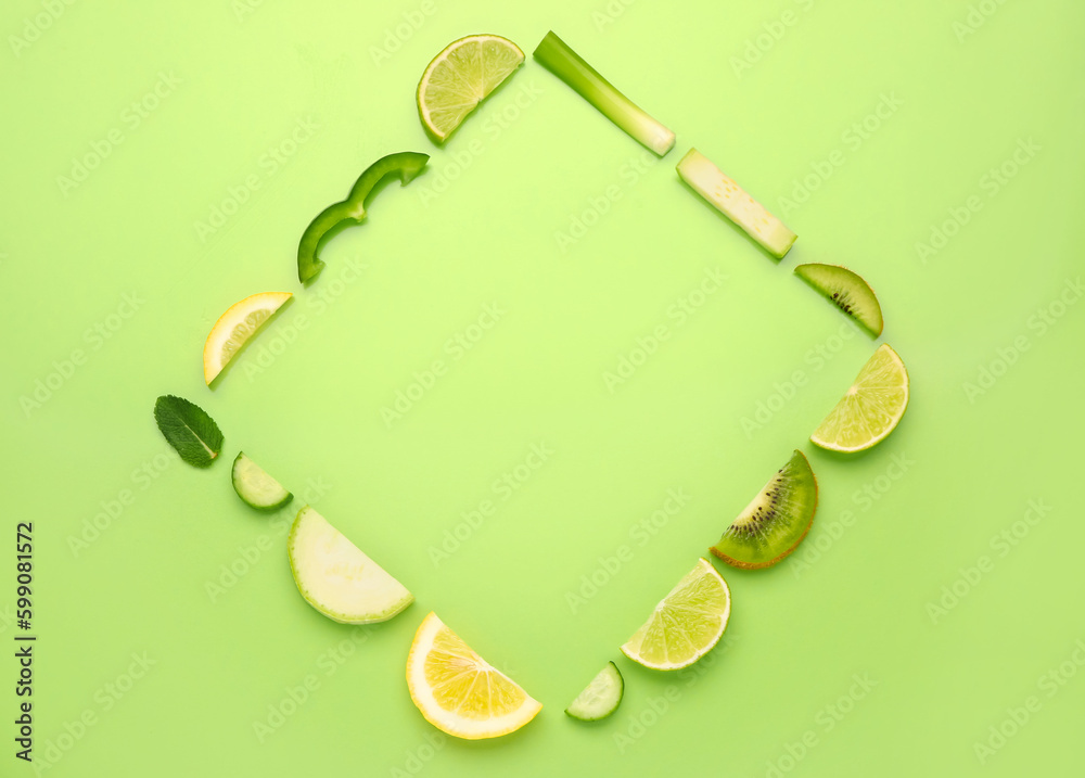 Frame made of fruits and vegetables on green background