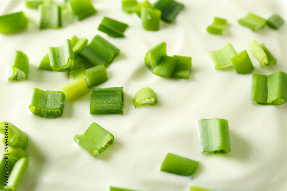 Sliced green onion on sour cream