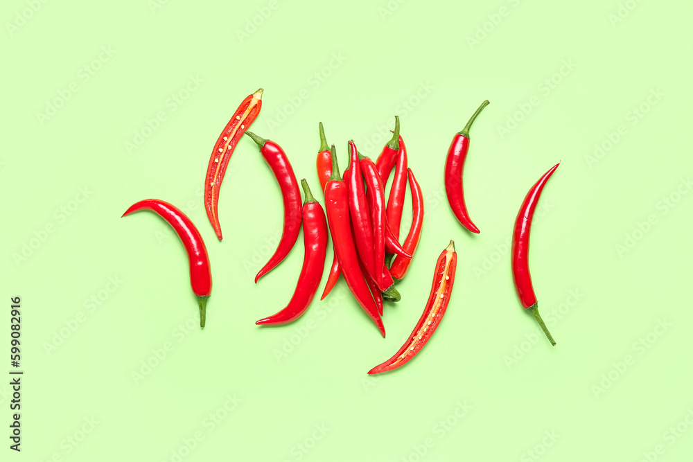 Fresh hot chili peppers on pale green background