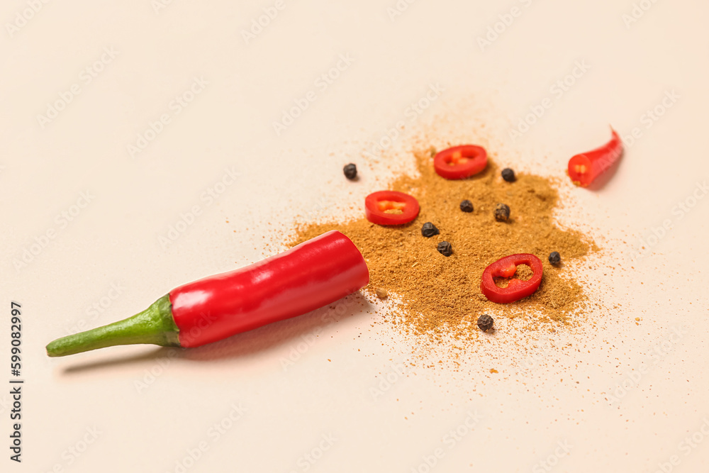 Fresh chili pepper and spices on pale orange background