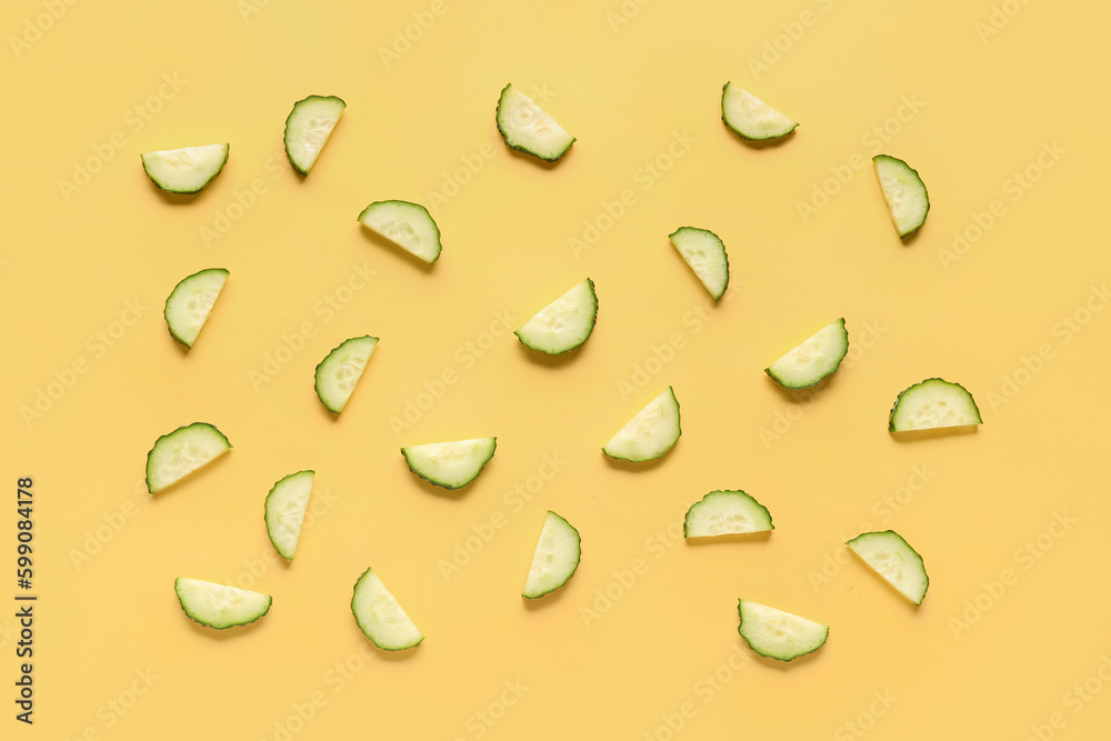 Slices of cucumber on yellow background