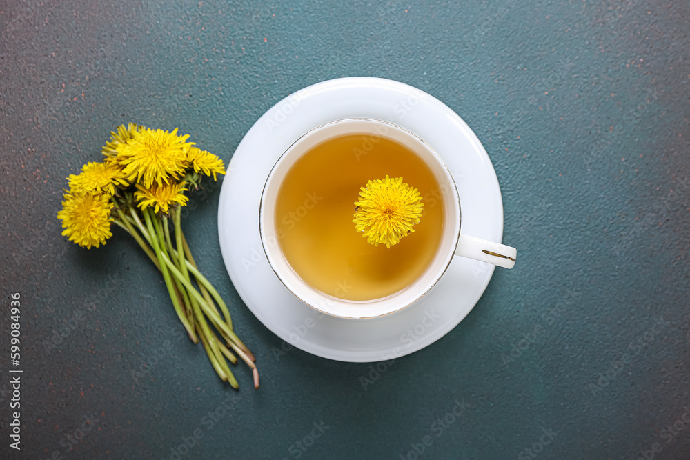 Cup of healthy dandelion tea on dark background