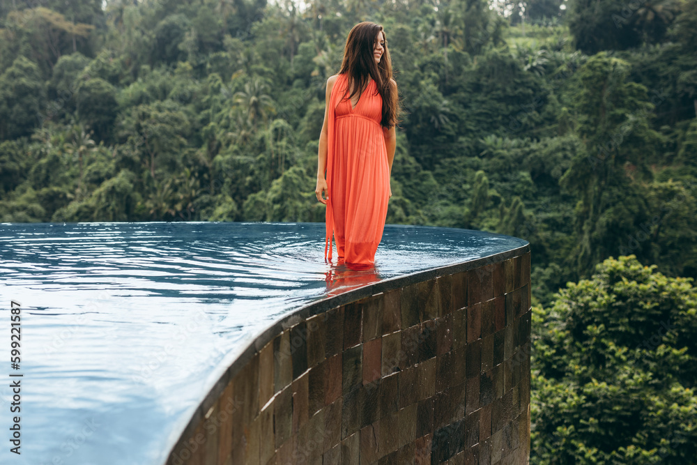 Young woman in swimming pool looking away at view