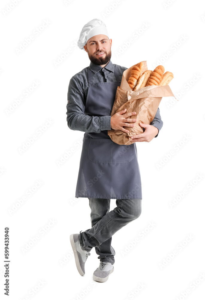 Male baker with fresh baguettes on white background