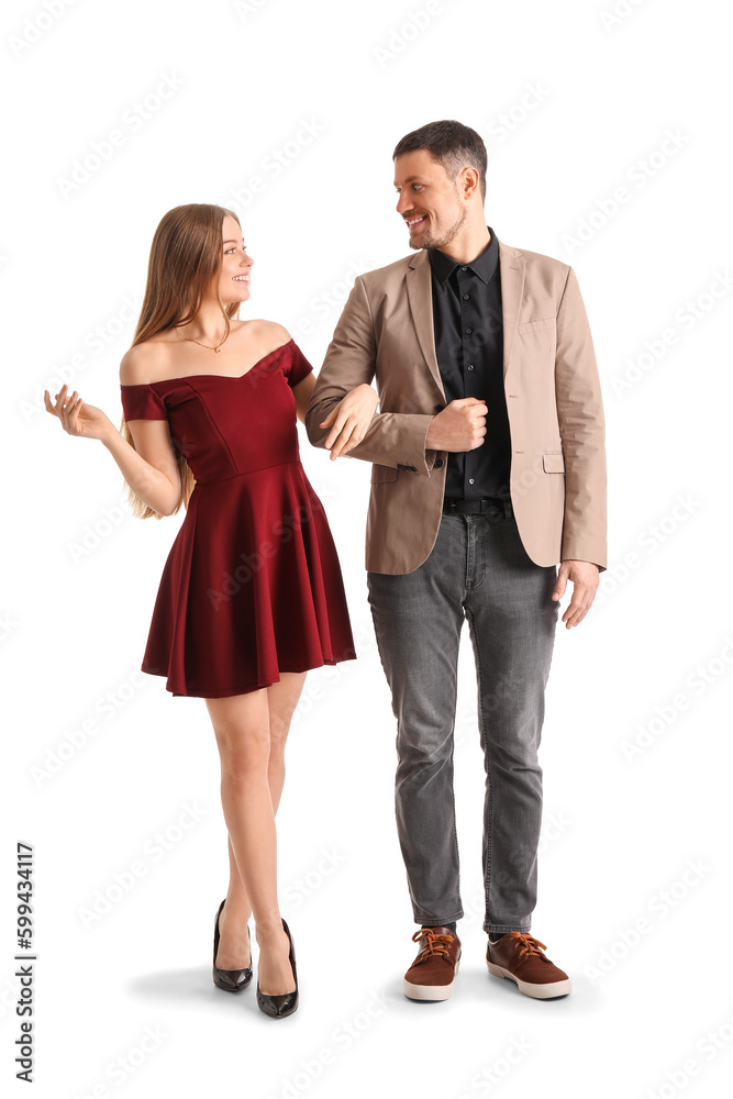 Elegant young couple walking hand in hand on white background