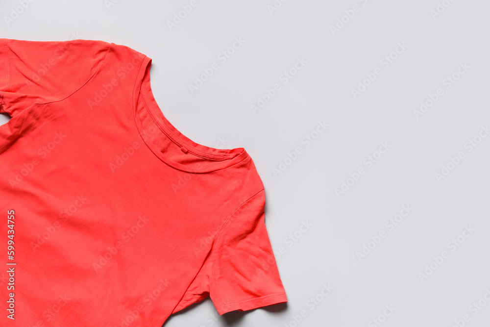 Red female t-shirt on light background