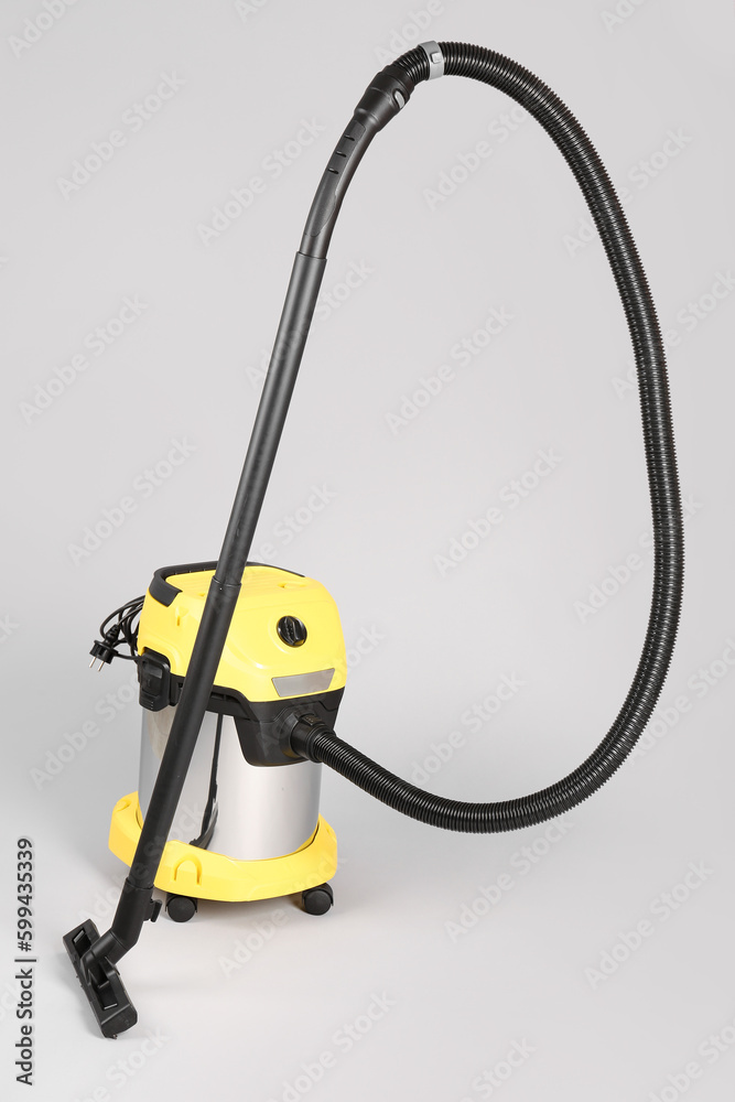 Vacuum cleaner on grey background