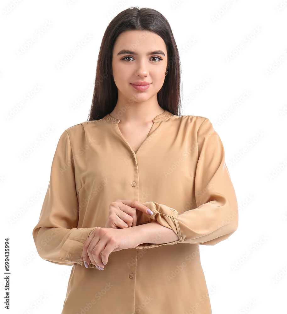 Beautiful young woman rolling up her sleeve on white background