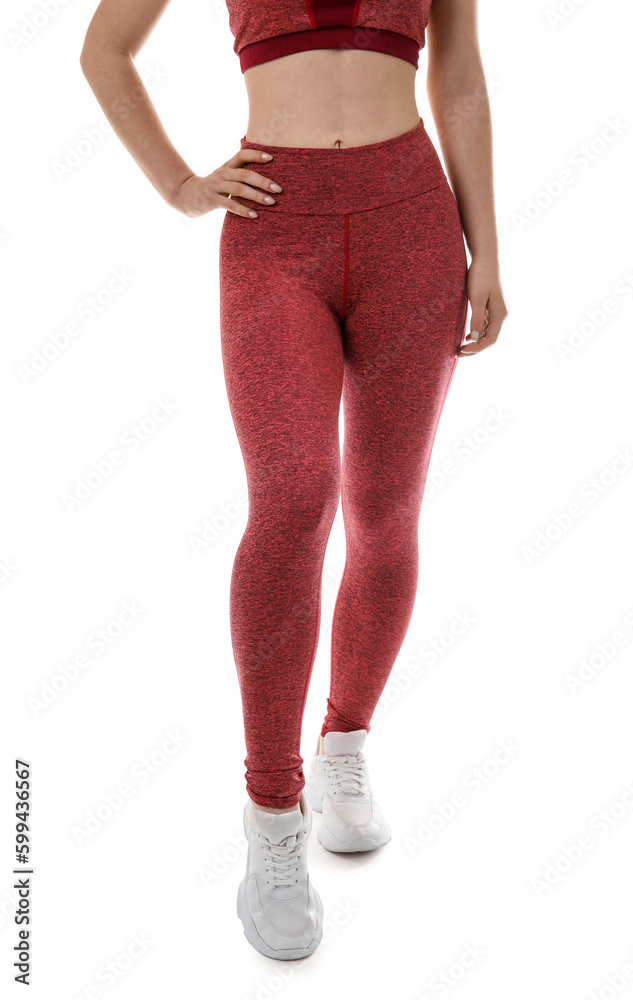 Sporty young woman in leggings on white background