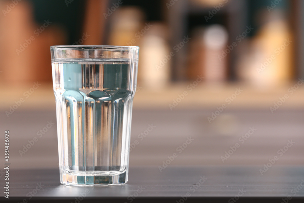 Glass of water on black table in kitchen