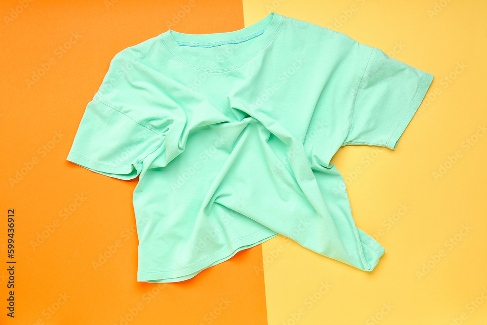 Crumpled blue t-shirt on colorful background