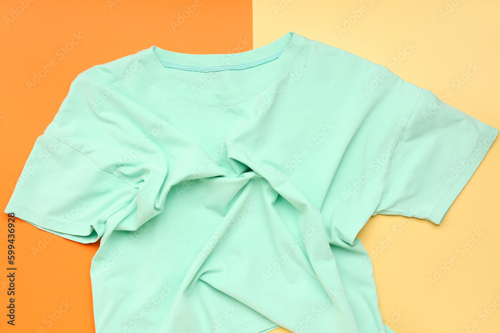 Crumpled blue t-shirt on colorful background