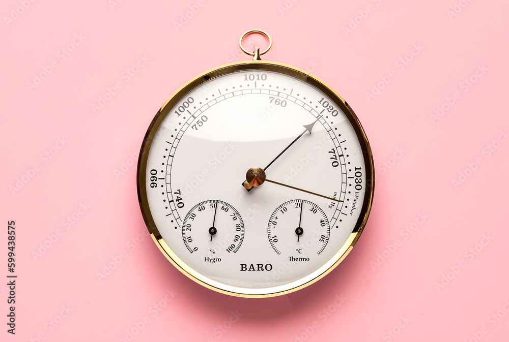 Aneroid barometer on pink background