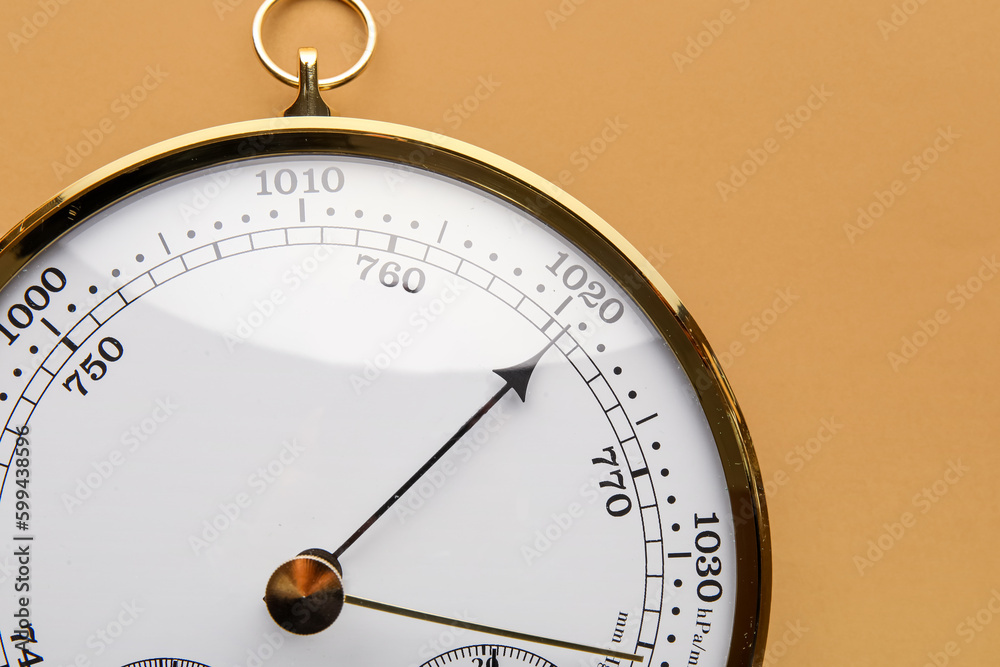 Aneroid barometer on brown background