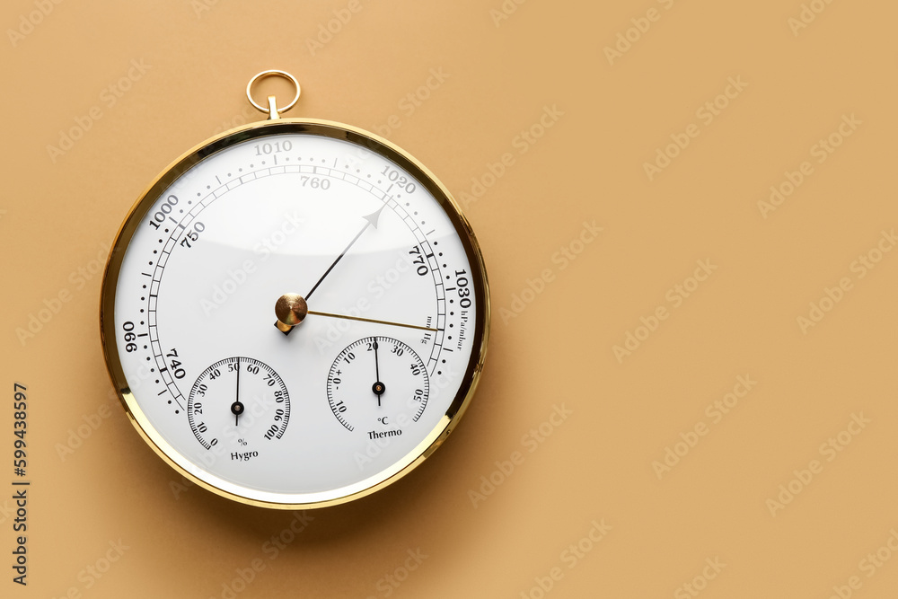 Aneroid barometer on brown background