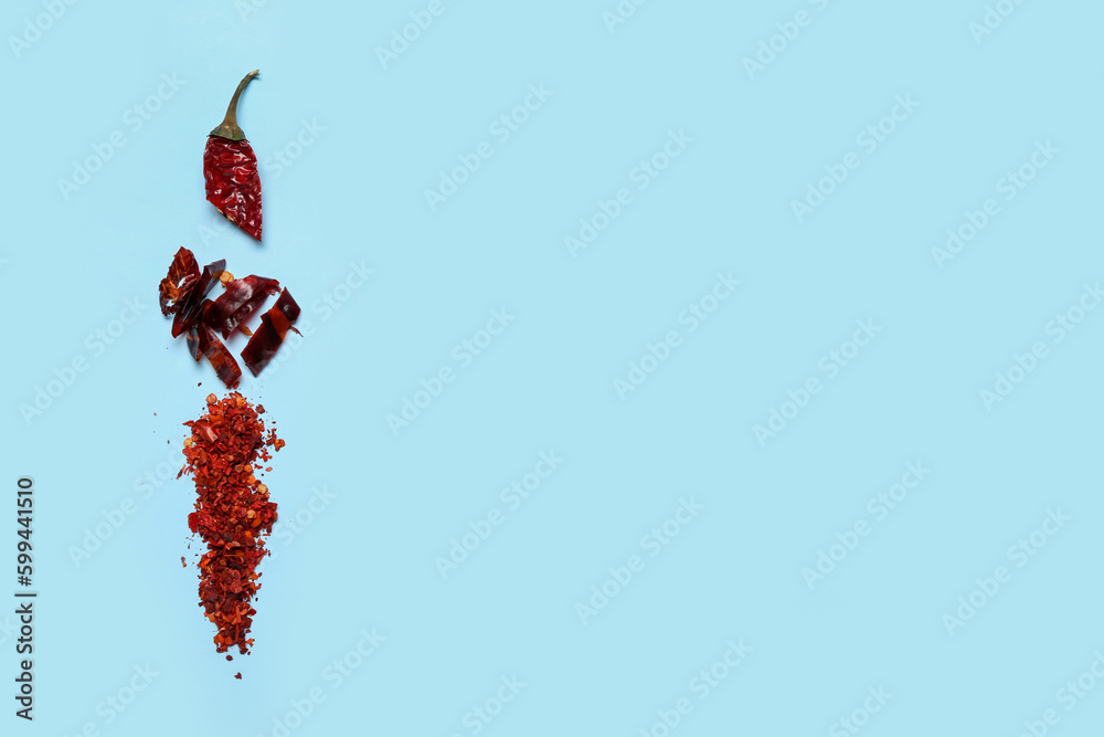 Composition with dry hot chili peppers on blue background