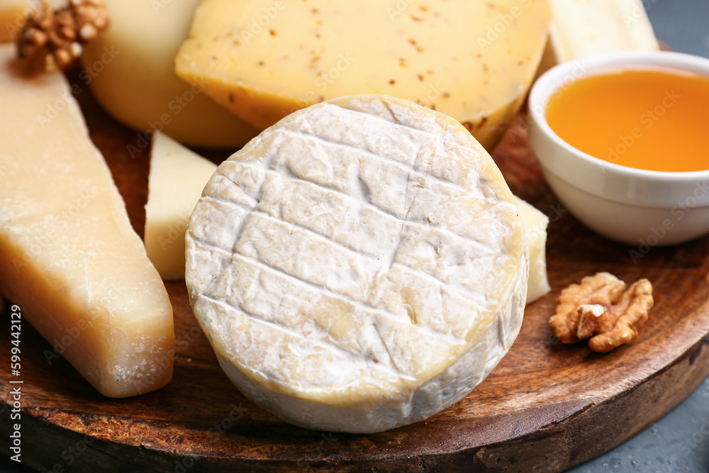 Plate with tasty cheese on table, closeup