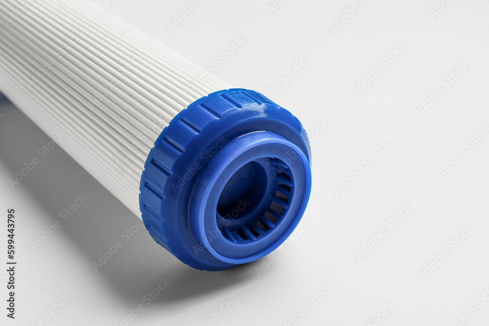 New water filter cartridge on grey background, closeup