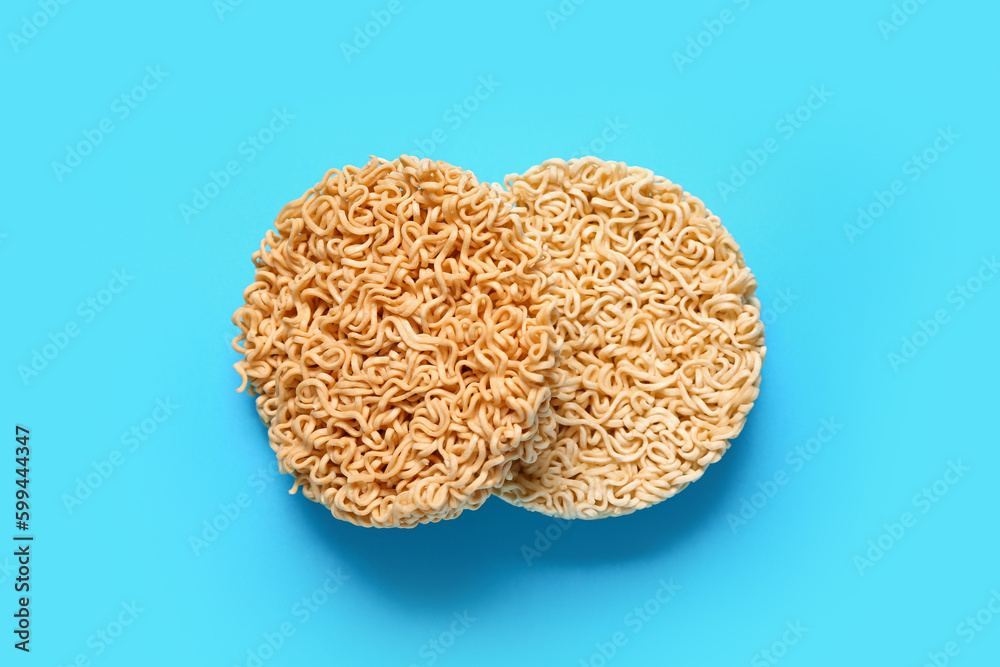 Raw instant noodles on blue background