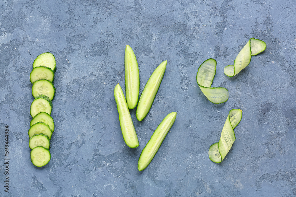 Pieces of fresh cucumber on blue background