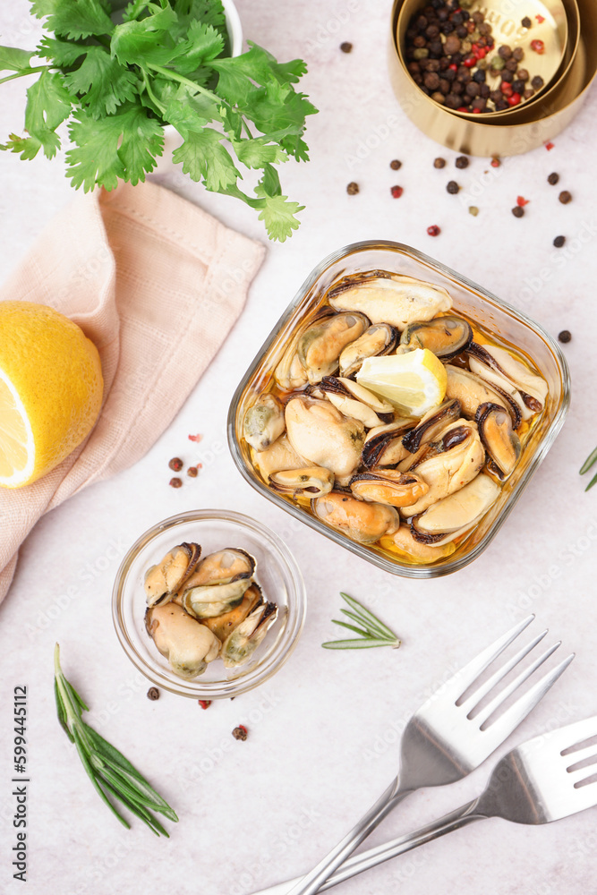 Bowls with pickled mussels on white background