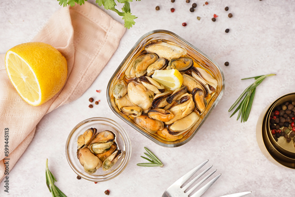 Bowls with pickled mussels on white background