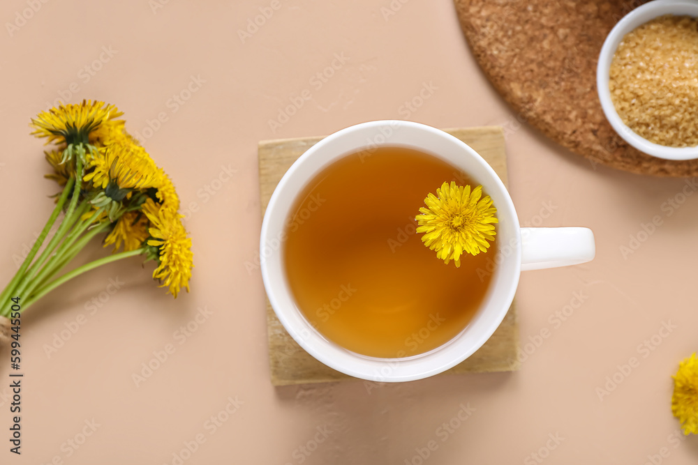 Cup of healthy dandelion tea on beige background