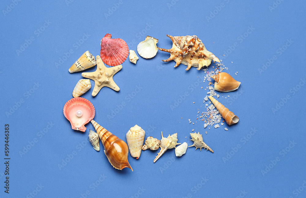 Frame made of sea shells, salt and starfish on blue background