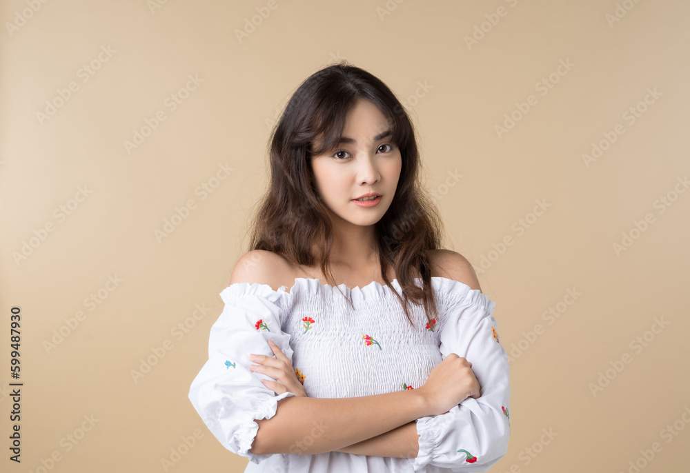 Portrait young Asian woman in cute dress isolated on brown background.