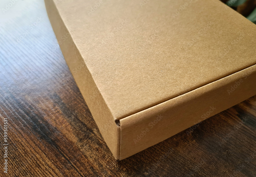 Carboard box mockup. Template of a carton packaging on wooden surface