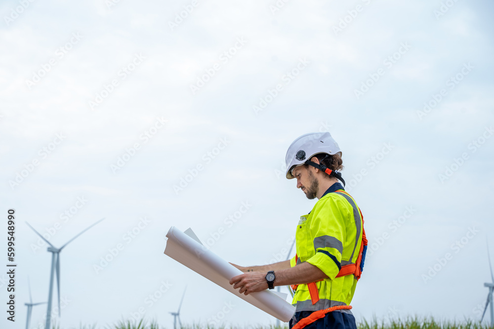 Engineer checking control electric power at windmill farm,Generating electricity clean energy.