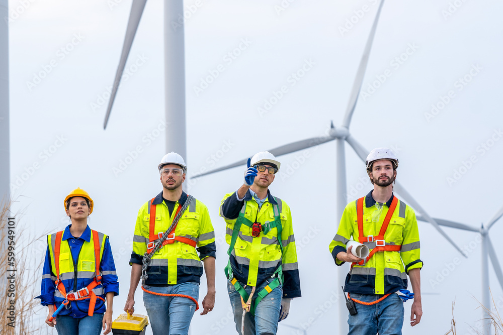 Group of engineers are working with a blueprint in wind turbine farm,Wind power station,Renewable an