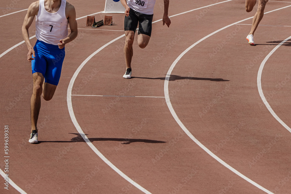 three male athlete runners starting running sprint race, summer athletics championships