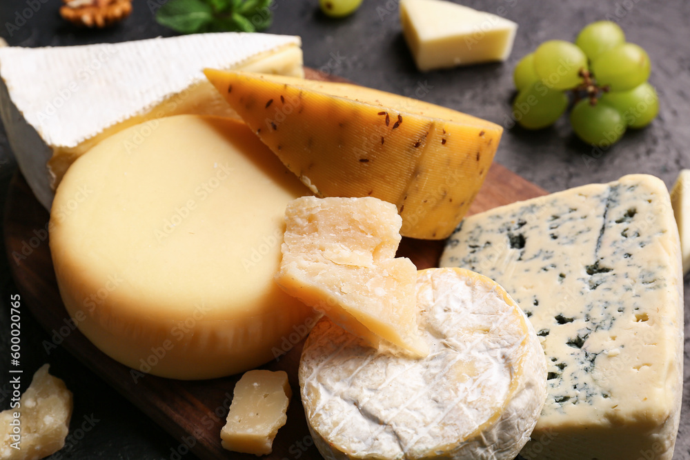 Different types of tasty cheese on table, closeup