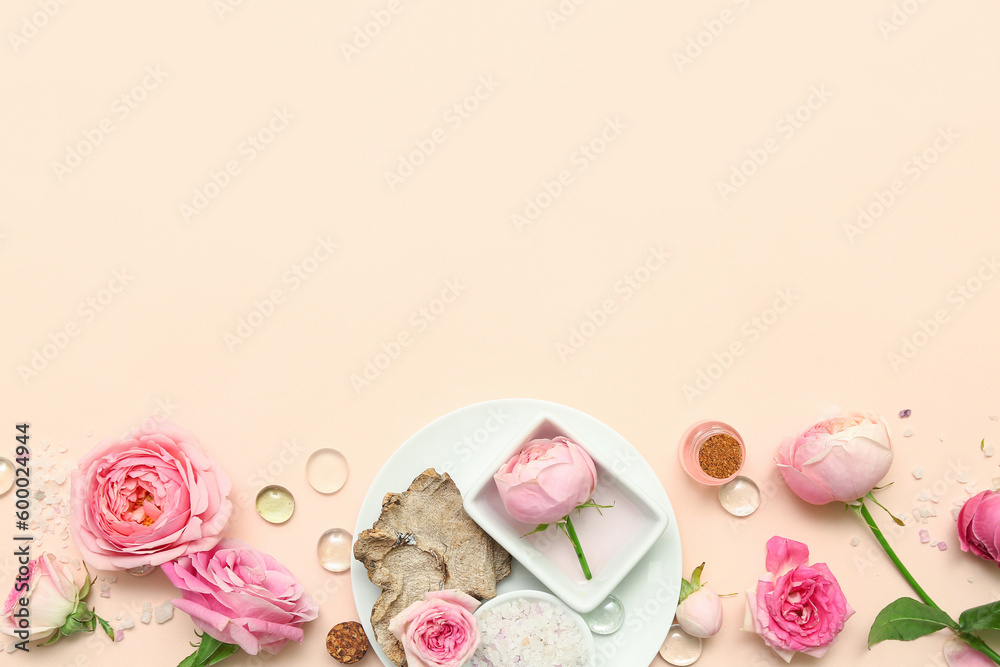 Bottles of cosmetic oil with rose extract and flowers on beige background