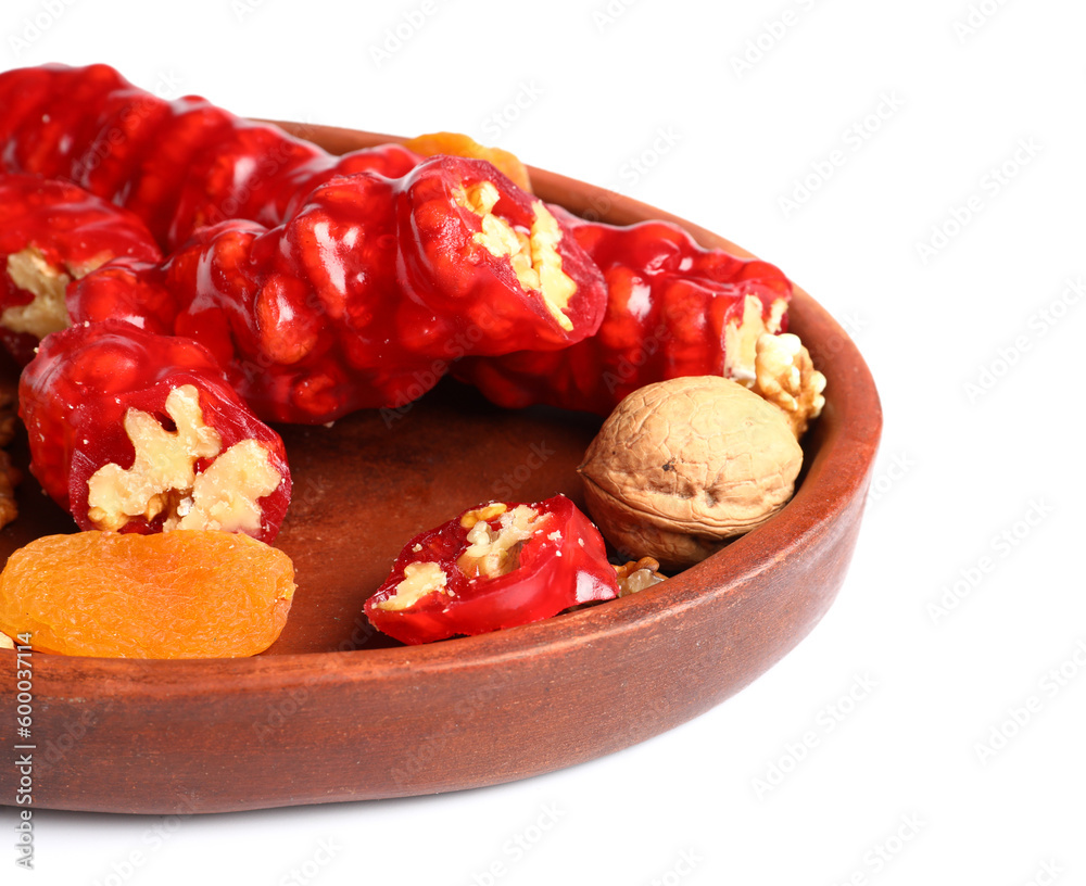 Plate with tasty churchkhela on white background, closeup