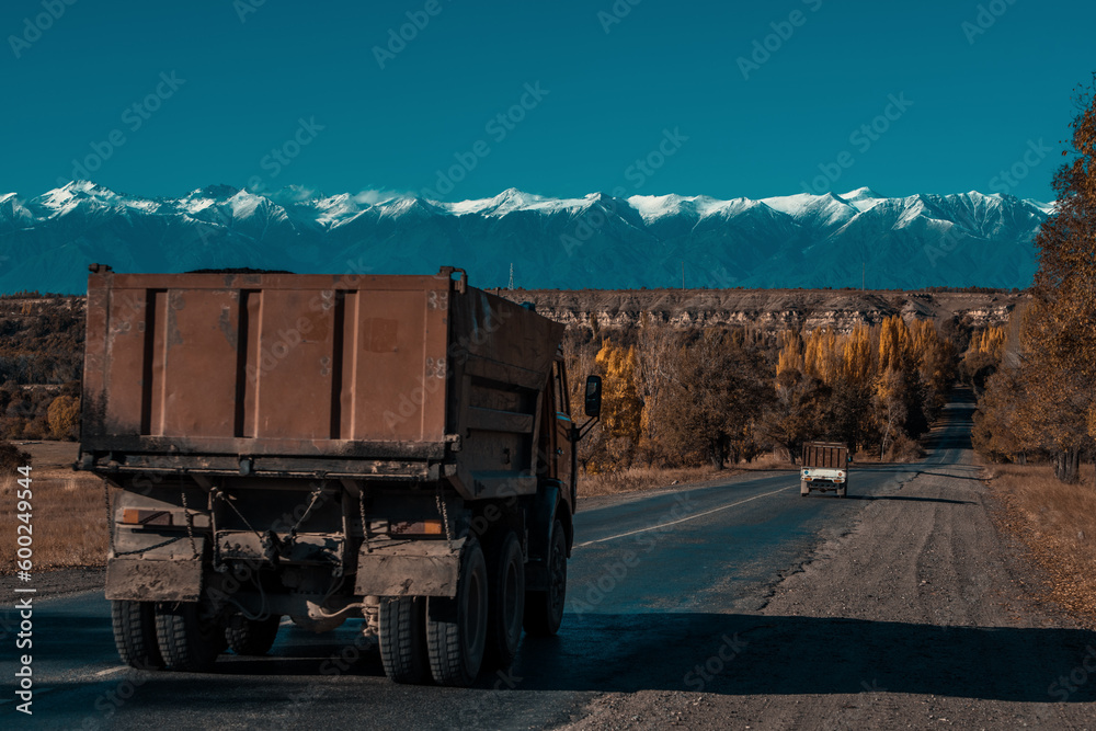 Old trucks on a road in the mountains