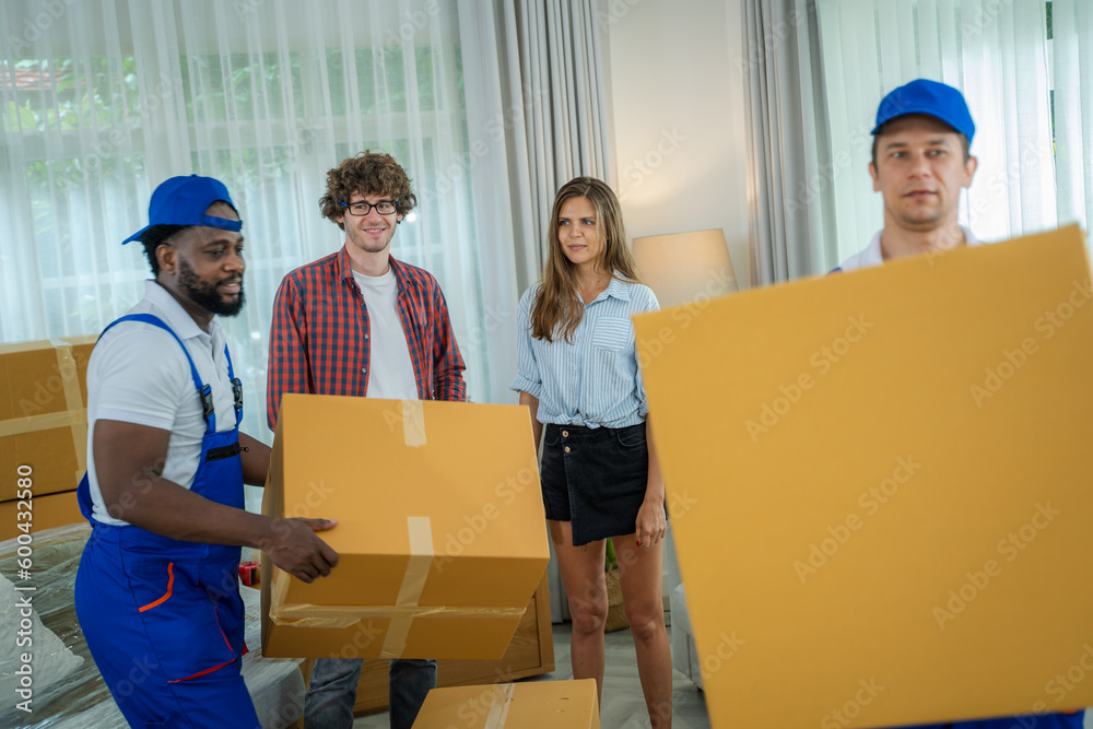 Two removal company workers are delivery service removing things from the house,Carrying furniture a