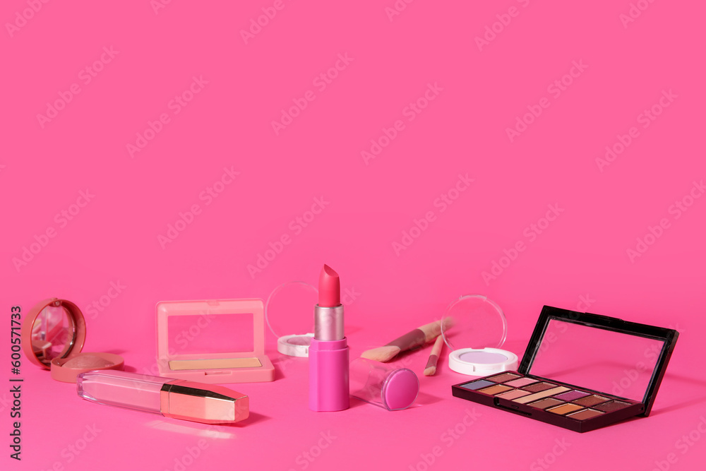 Lipstick and different cosmetics on pink background