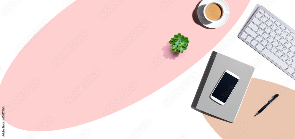 Desk items - keyboard, smart phone, coffee and a pen on a desk from above