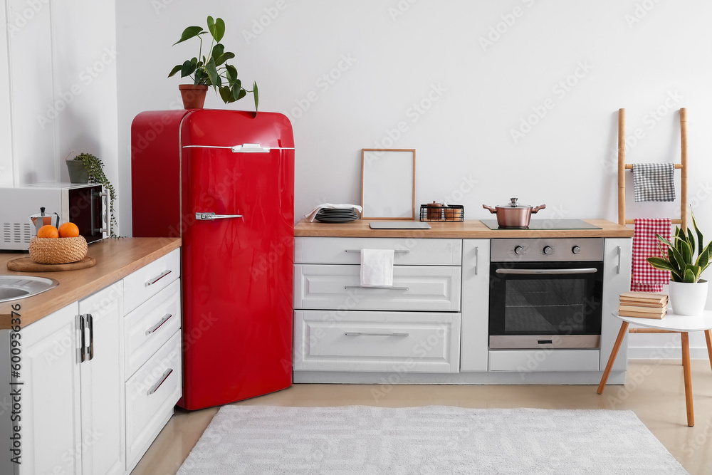 Interior of modern kitchen with stylish refrigerator