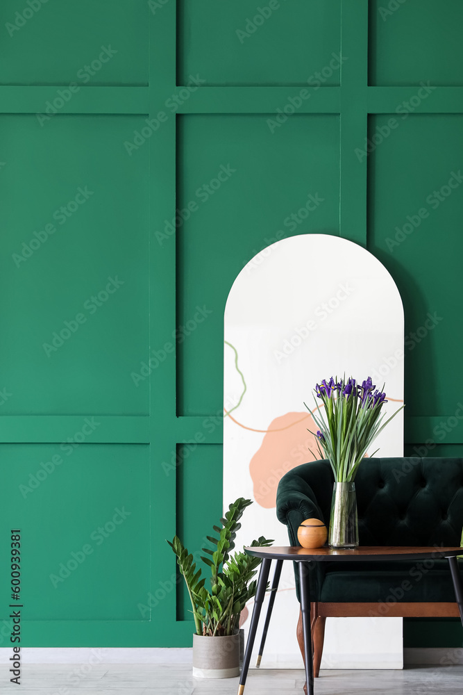 Interior of living room with sofa, table and big mirror