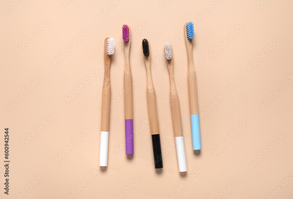 Bamboo toothbrushes on brown background