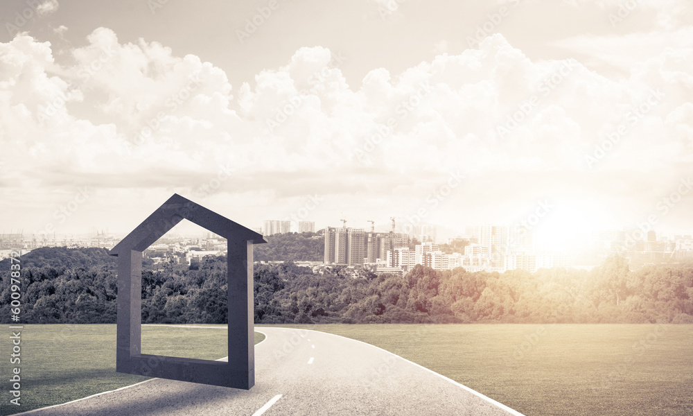 Conceptual background image of concrete home sign on asphalt road