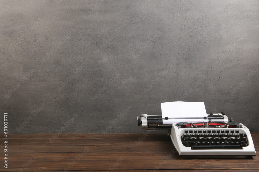 vintage typewriter on the table with blank paper on wooden desk - concept for writing, journalism, b