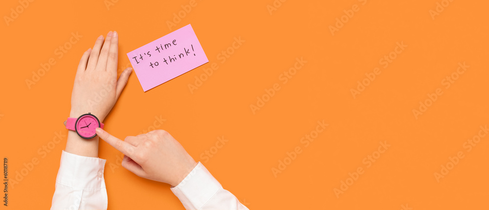 Woman pointing at watch and paper with text ITS TIME TO THINK on orange background with space for t