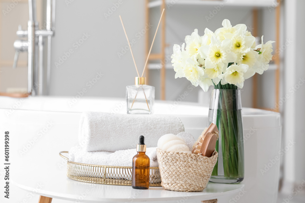 Bathing supplies and bouquet of flowers on table