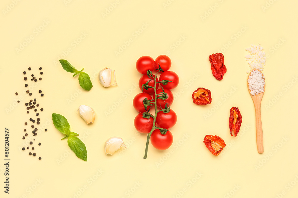 Composition with ingredients for pizza sauce on yellow background