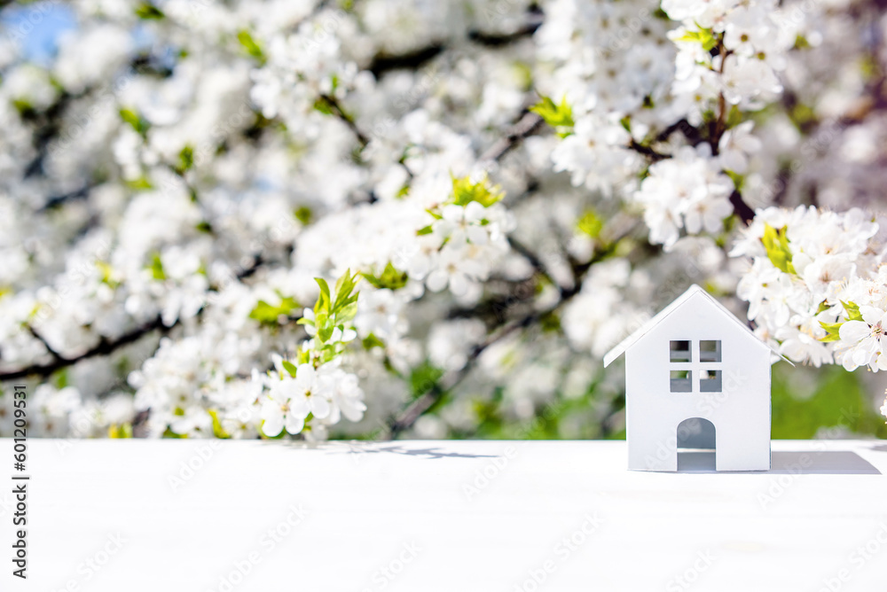 The symbol of the house stands against a background of cherry blossoms 